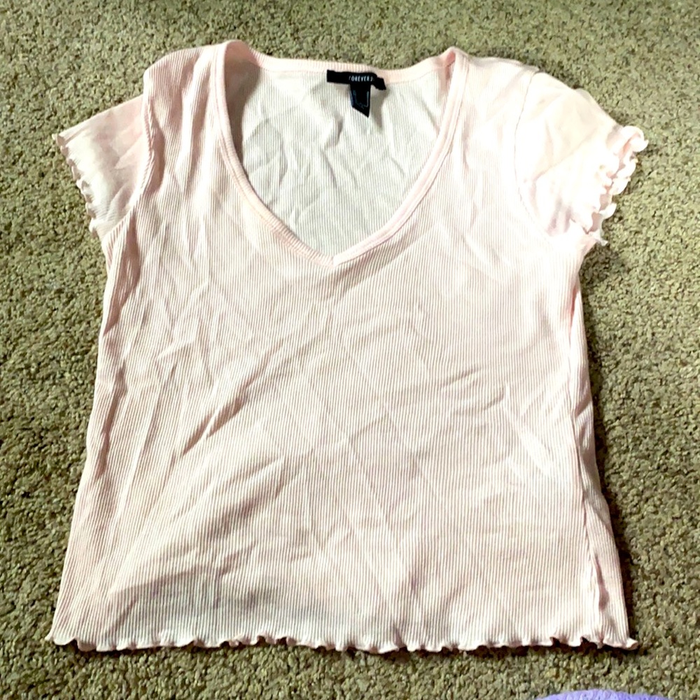 Baby pink shirt with ruffles at the bottom, size M
